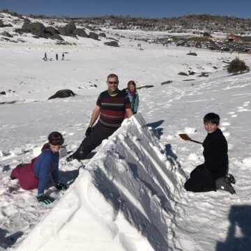 Scouts building snow shelters during the annual Family Snow Trip