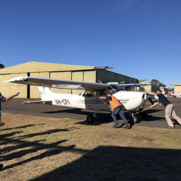 Pushing the plane back into the hangar at the Family Air Activity Day